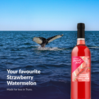 Island Mist Strawberry Watermelon bottle by the ocean