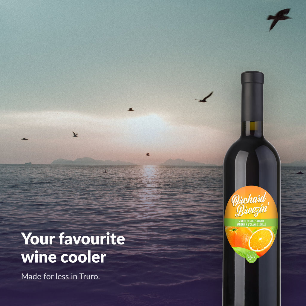 Orchard Breezin' Seville Orange Sangria bottle above a coastal sunrise