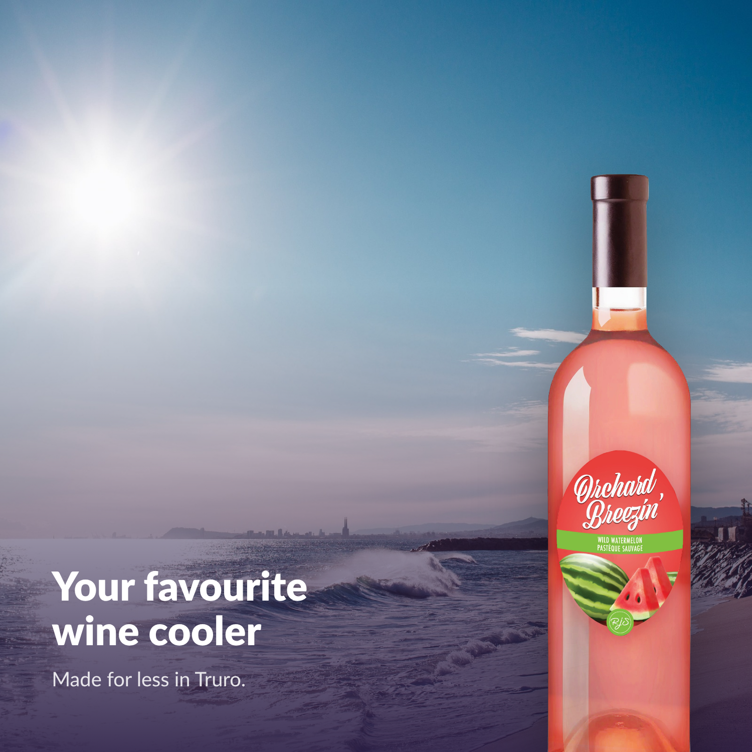 Orchard Breezin' Wild Watermelon bottle on a bright Atlantic Canadian beach