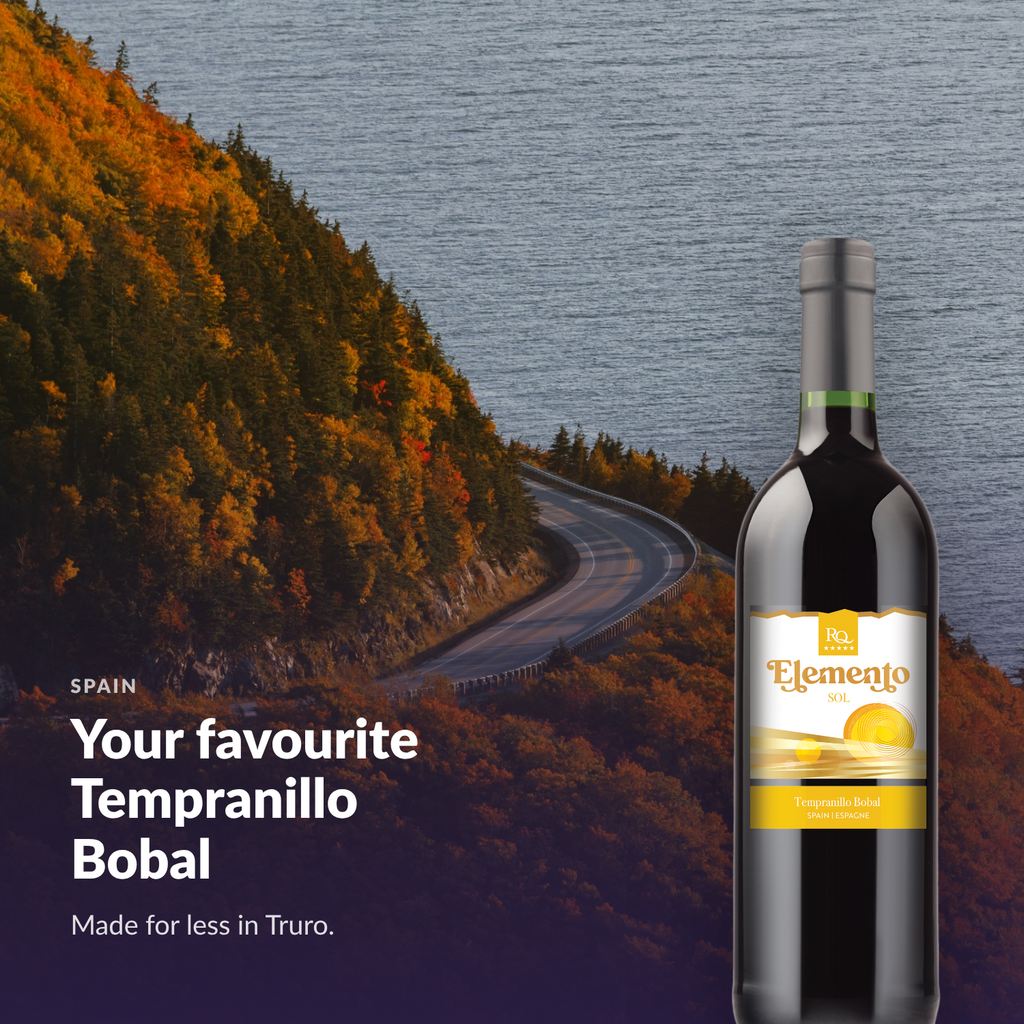 Bottle of RQ27 Tempranillo Bobal in a warm coastal setting